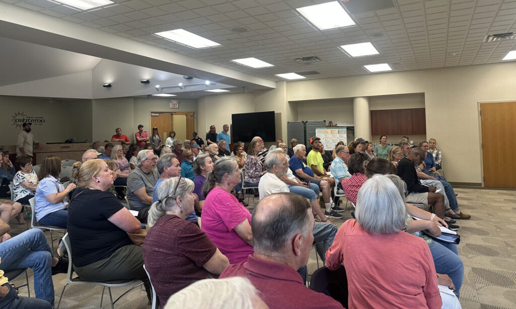 Standing-room-only Oshtemo Township meeting shows residents are organizing against the proposed S. Van Kal BESS and demanding responsible energy siting, transparency, and protection of rural residential areas.