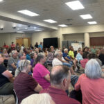 Standing-room-only Oshtemo Township meeting shows residents are organizing against the proposed S. Van Kal BESS and demanding responsible energy siting, transparency, and protection of rural residential areas.